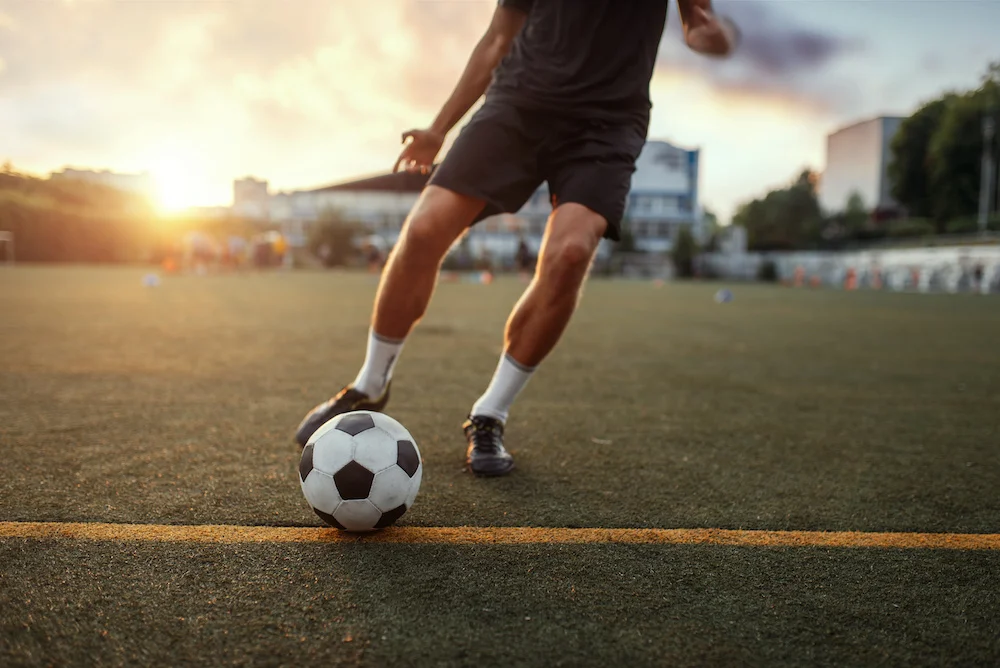 A person prepares to kick a soccer ball with their right foot