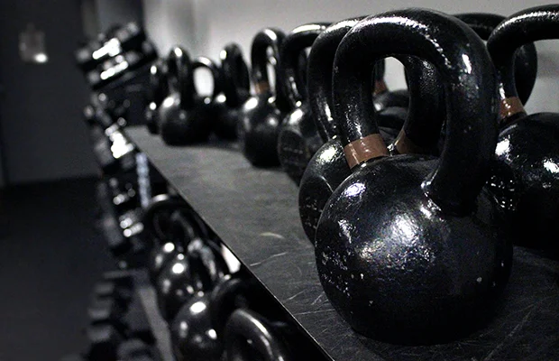 Kettlebells resting on a kettlebell rack